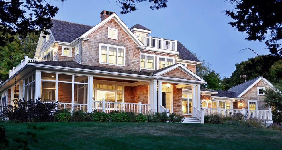 Photo of a mid-sized beach style three-storey brown house exterior in Boston with wood siding, a hip roof and a shingle roof.