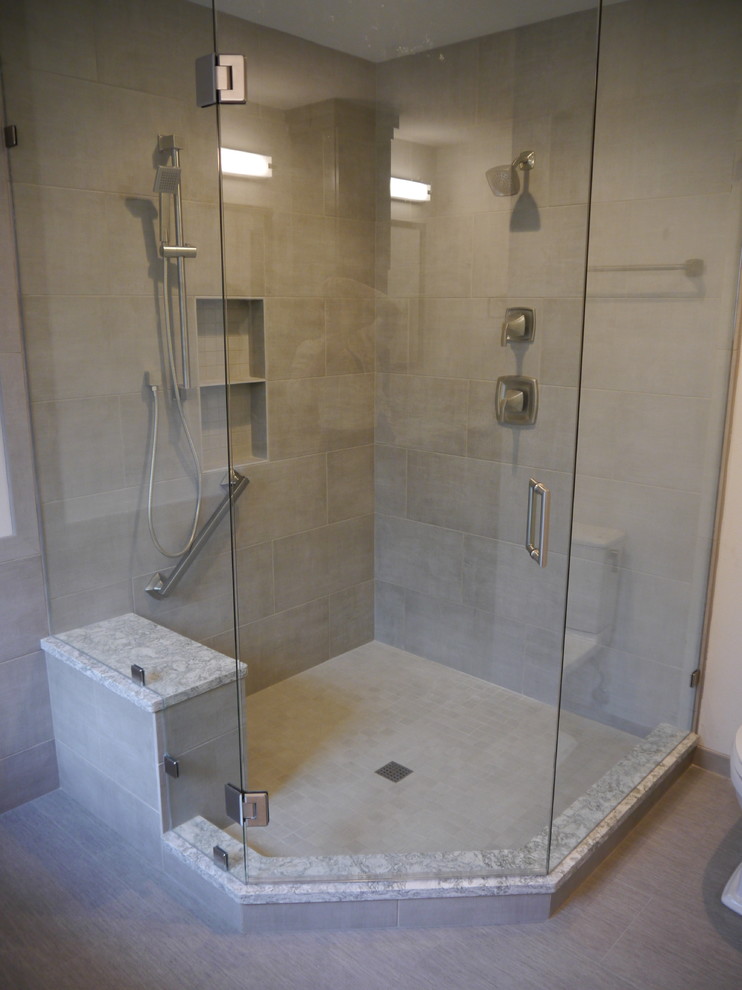 Design ideas for a large master bathroom in Seattle with shaker cabinets, grey cabinets, a freestanding tub, a corner shower, a two-piece toilet, gray tile, porcelain tile, white walls, vinyl floors, an undermount sink, solid surface benchtops, grey floor, a hinged shower door and multi-coloured benchtops.