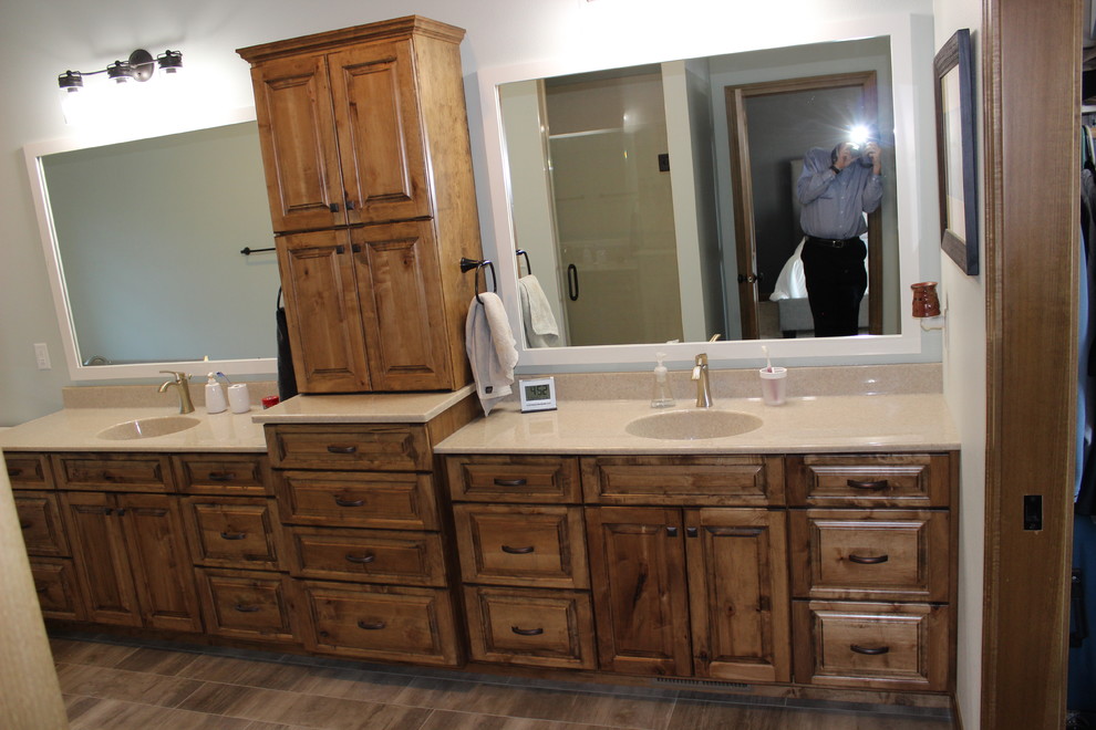 Design ideas for a mid-sized country master bathroom in Other with raised-panel cabinets, medium wood cabinets, white walls, porcelain floors, an integrated sink, laminate benchtops and beige floor.