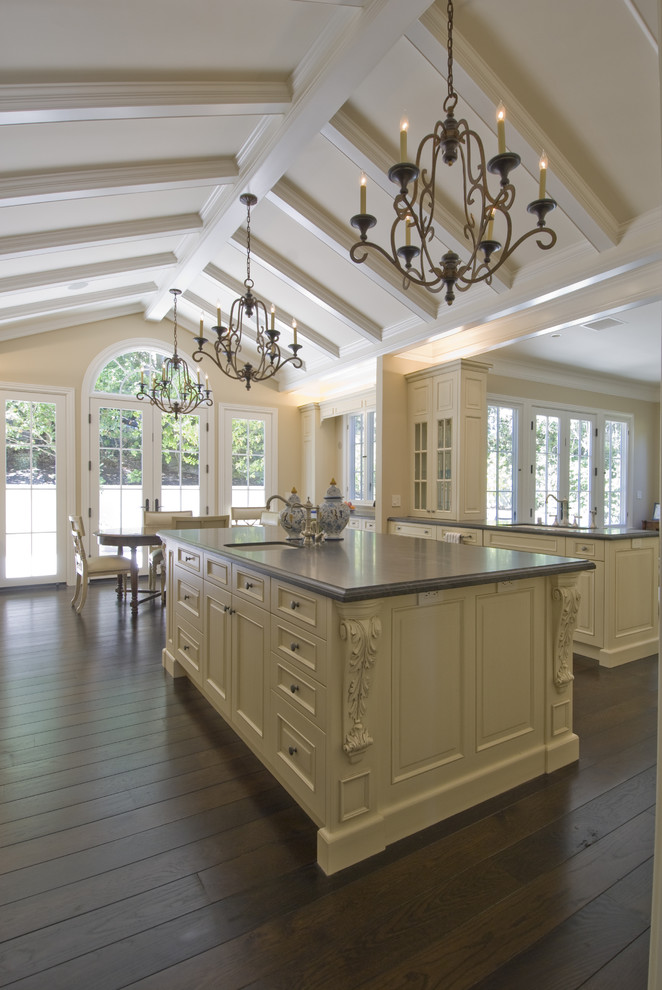 This is an example of a traditional eat-in kitchen in San Francisco with recessed-panel cabinets and beige cabinets.