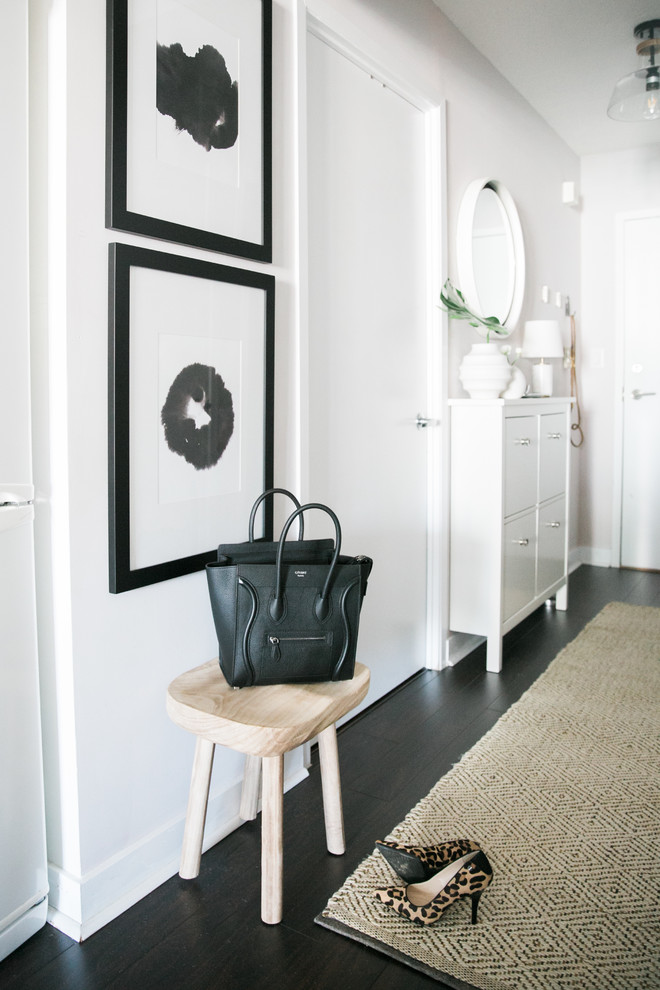 Design ideas for a small eclectic hallway in Toronto with grey walls and dark hardwood floors.