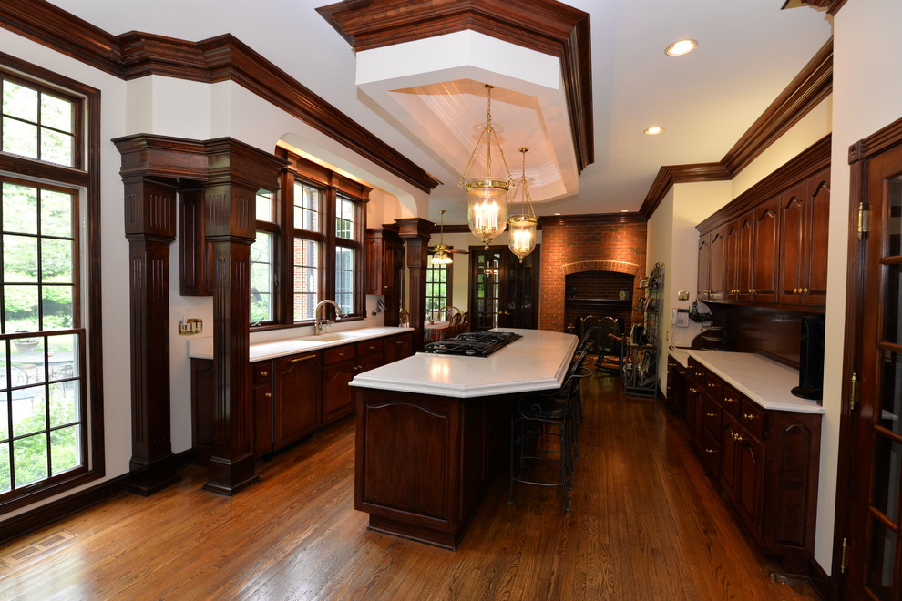 Mid-sized transitional medium tone wood floor open concept kitchen photo in Chicago with an integrated sink, beaded inset cabinets, dark wood cabinets, quartz countertops and an island