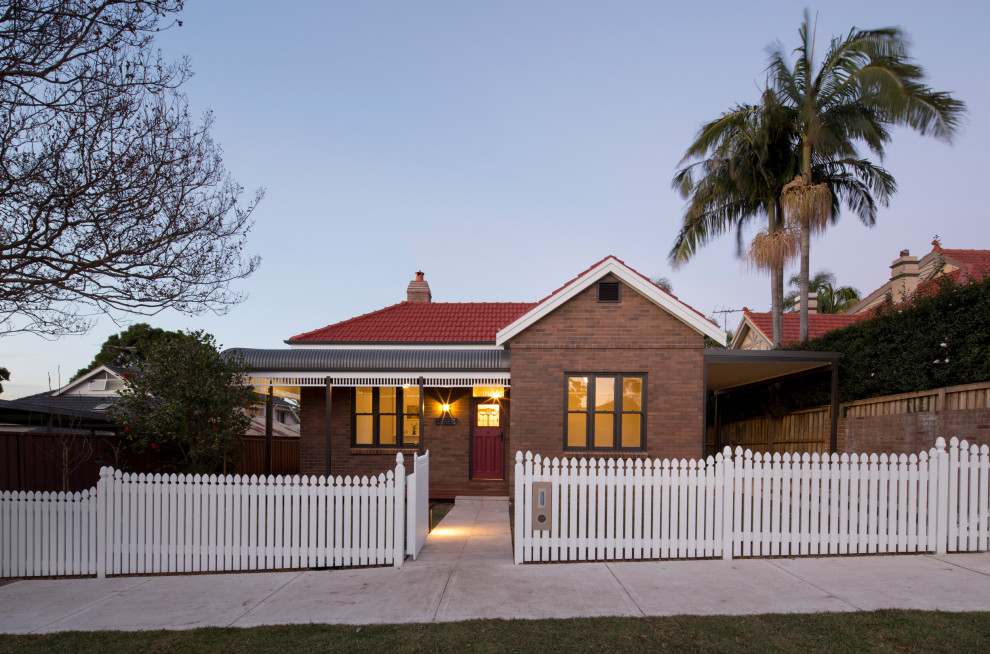 Design ideas for a mid-sized traditional one-storey brick brown house exterior in Sydney with a gable roof and a tile roof.
