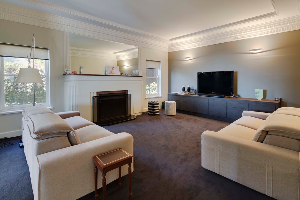 Inspiration for a large midcentury formal enclosed living room in Melbourne with beige walls, carpet, a standard fireplace, a stone fireplace surround and a freestanding tv.
