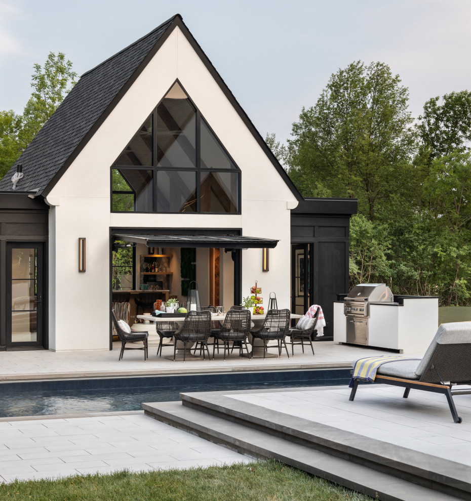 Foto de casa de la piscina y piscina minimalista en patio trasero con adoquines de piedra natural