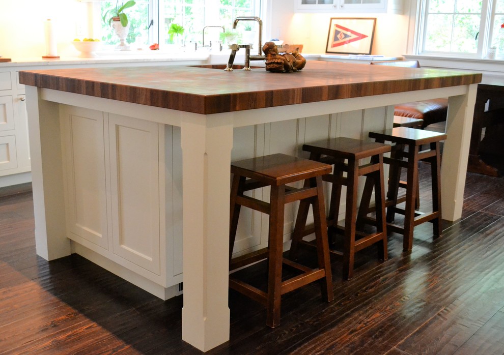 Large transitional l-shaped eat-in kitchen in Baltimore with a farmhouse sink, shaker cabinets, white cabinets, marble benchtops, multi-coloured splashback, cement tile splashback, stainless steel appliances, dark hardwood floors, with island and brown floor.