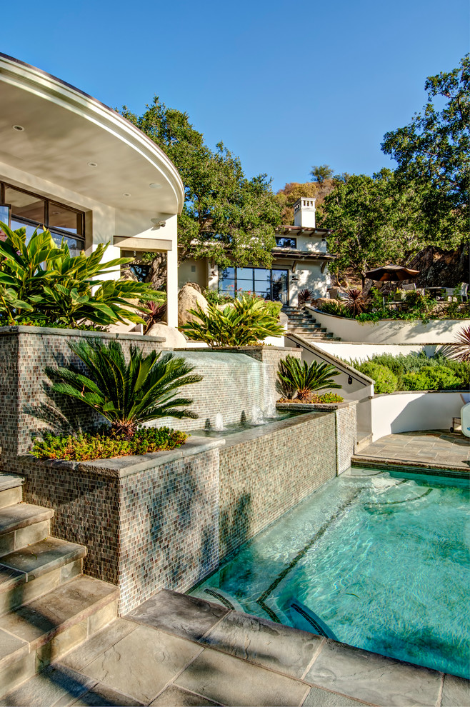 This is an example of a mediterranean rectangular pool in Santa Barbara with tile.
