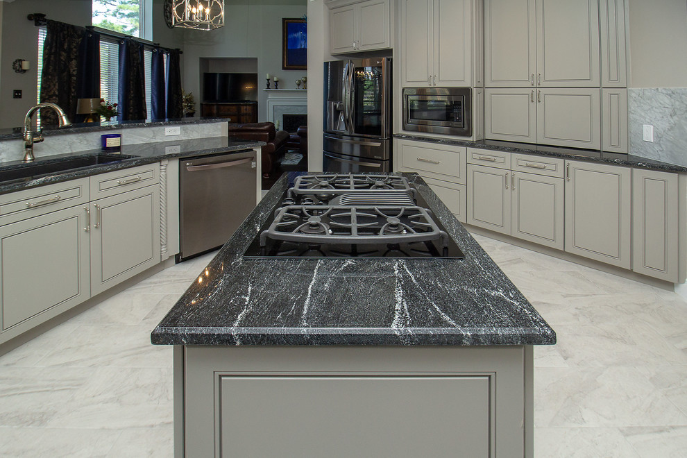 Inspiration for a large transitional l-shaped porcelain tile and white floor eat-in kitchen remodel in Houston with a single-bowl sink, beaded inset cabinets, gray cabinets, granite countertops, white backsplash, marble backsplash, stainless steel appliances, two islands and black countertops