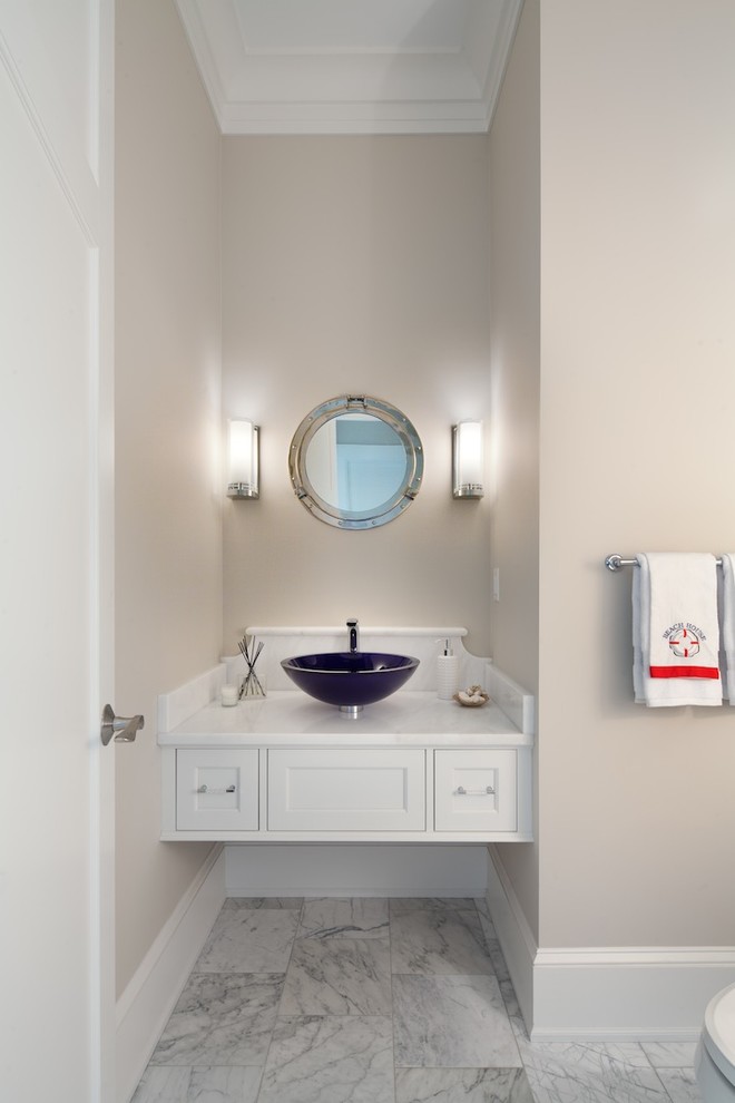 Design ideas for a beach style powder room in DC Metro with a vessel sink, white cabinets, beige walls, marble floors, shaker cabinets and white tile.