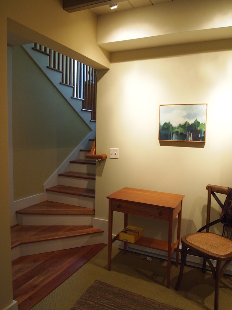 Contemporary wood u-shaped staircase in Boston with painted wood risers.