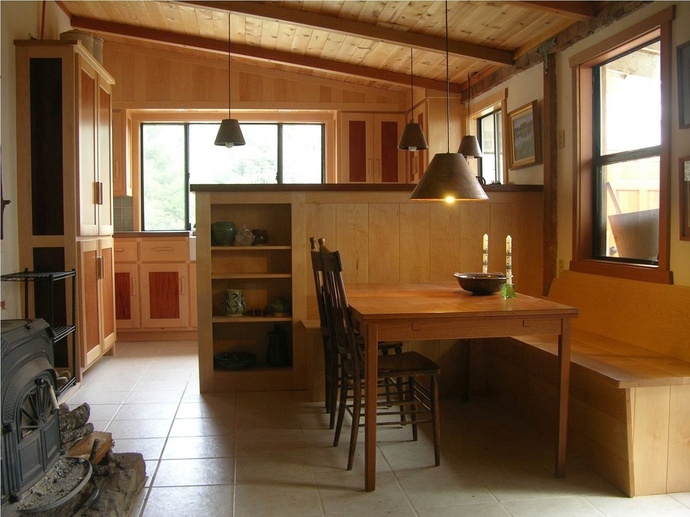 Example of a mid-sized mountain style u-shaped cement tile floor and beige floor open concept kitchen design with a farmhouse sink, shaker cabinets, light wood cabinets, concrete countertops, green backsplash, ceramic backsplash and white appliances