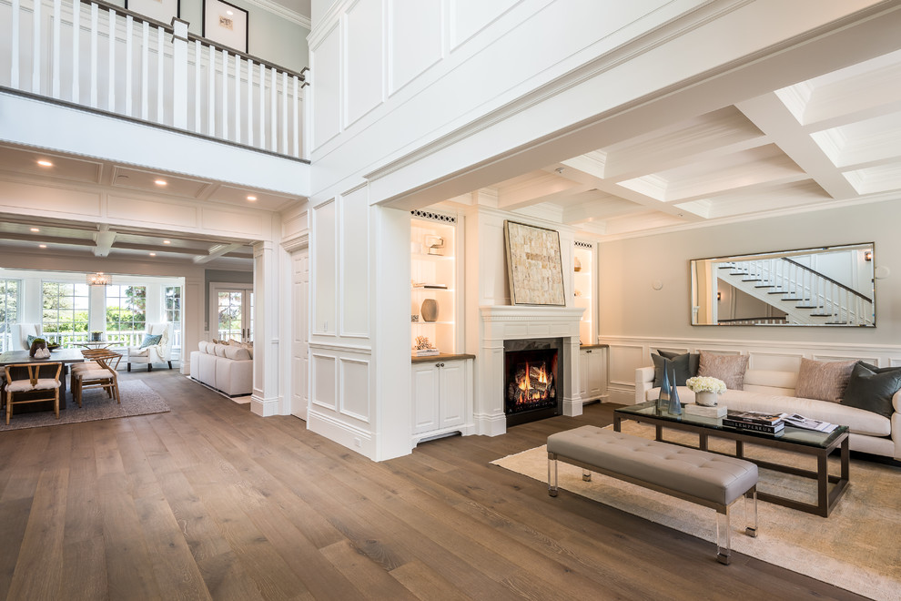 Large traditional foyer in Los Angeles with white walls, medium hardwood floors, a single front door, a white front door, beige floor, coffered and decorative wall panelling.