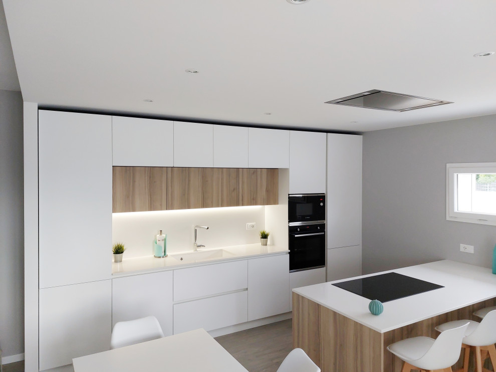 Photo of a large modern u-shaped kitchen/diner in Other with a submerged sink, flat-panel cabinets, white cabinets, engineered stone countertops, white splashback, engineered quartz splashback, black appliances, painted wood flooring, a breakfast bar, brown floors and white worktops.