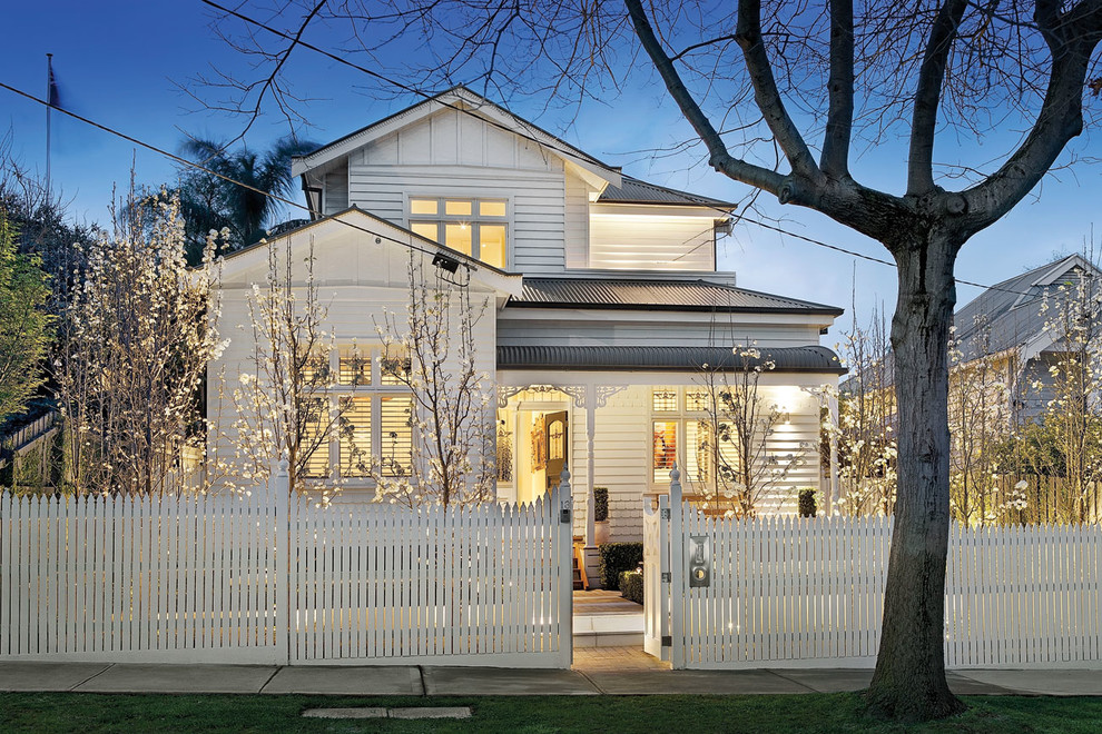 Traditional two-storey white exterior in Melbourne with wood siding.