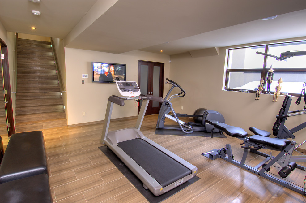 Inspiration for a mid-sized contemporary multipurpose gym in Toronto with beige walls, porcelain floors and brown floor.