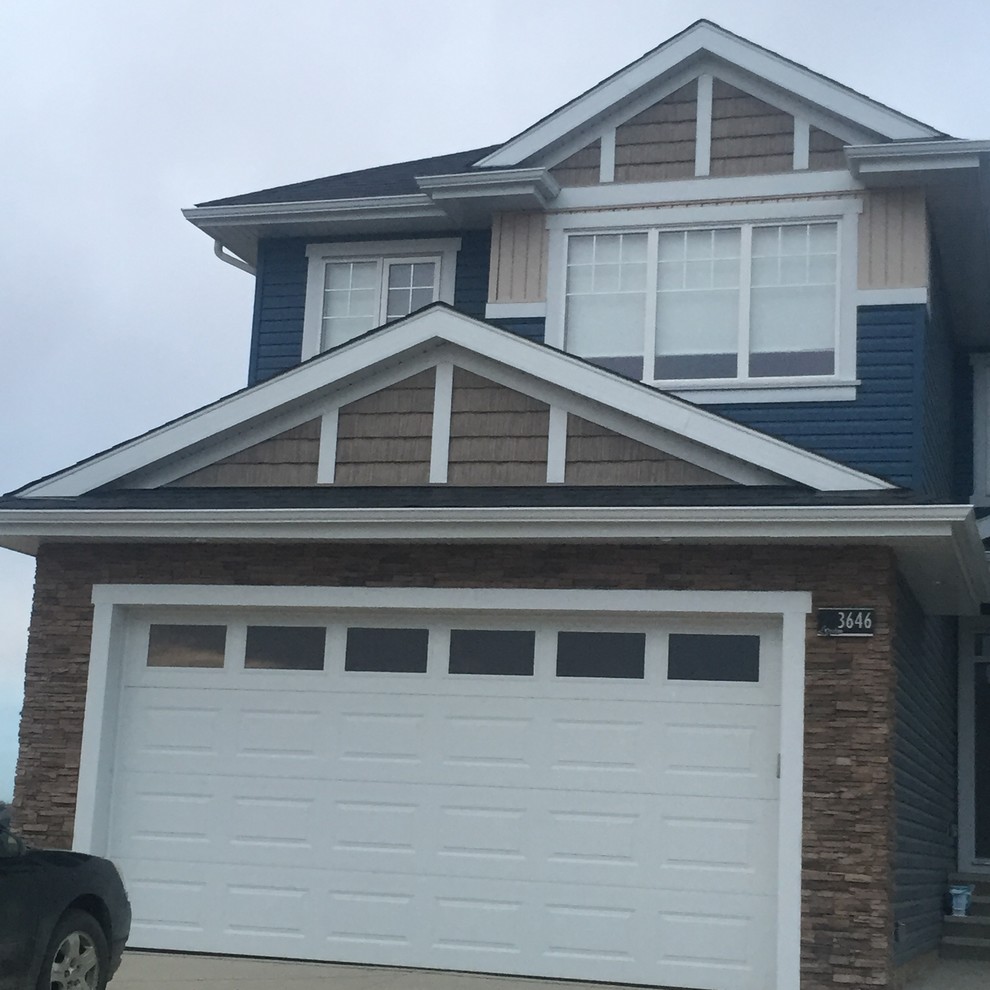 Example of a transitional exterior home design in Calgary