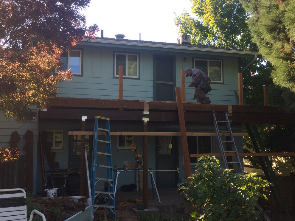 Small backyard second story wood railing deck photo with no cover