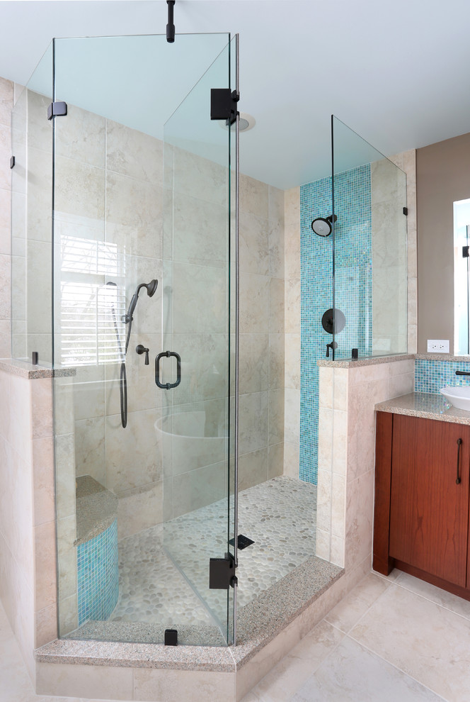 Photo of a mid-sized contemporary master bathroom in Chicago with flat-panel cabinets, medium wood cabinets, engineered quartz benchtops, a corner shower, gray tile, grey walls and pebble tile floors.