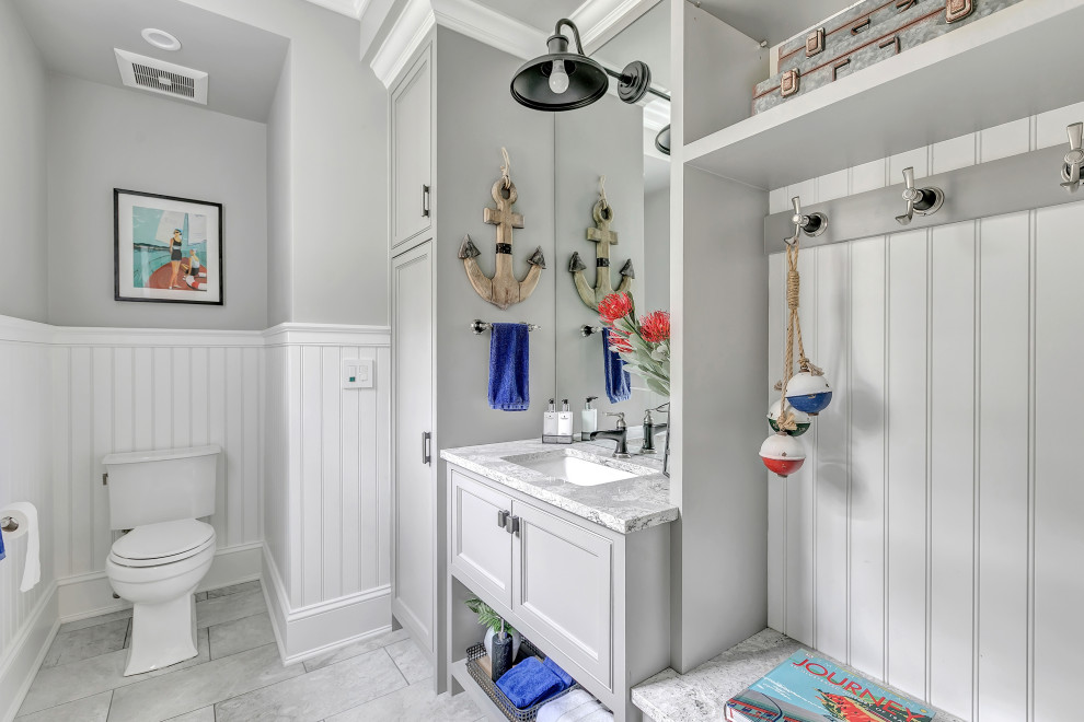 This is an example of a mid-sized transitional 3/4 bathroom in New York with recessed-panel cabinets, white cabinets, an alcove shower, a two-piece toilet, white tile, mosaic tile, grey walls, porcelain floors, an undermount sink, engineered quartz benchtops, beige floor, a sliding shower screen and white benchtops.