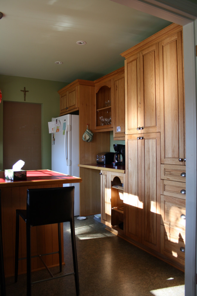 Eclectic galley dark wood floor, brown floor and coffered ceiling kitchen photo in Montreal with an undermount sink, flat-panel cabinets, quartzite countertops, white backsplash, mosaic tile backsplash, stainless steel appliances, an island and white countertops
