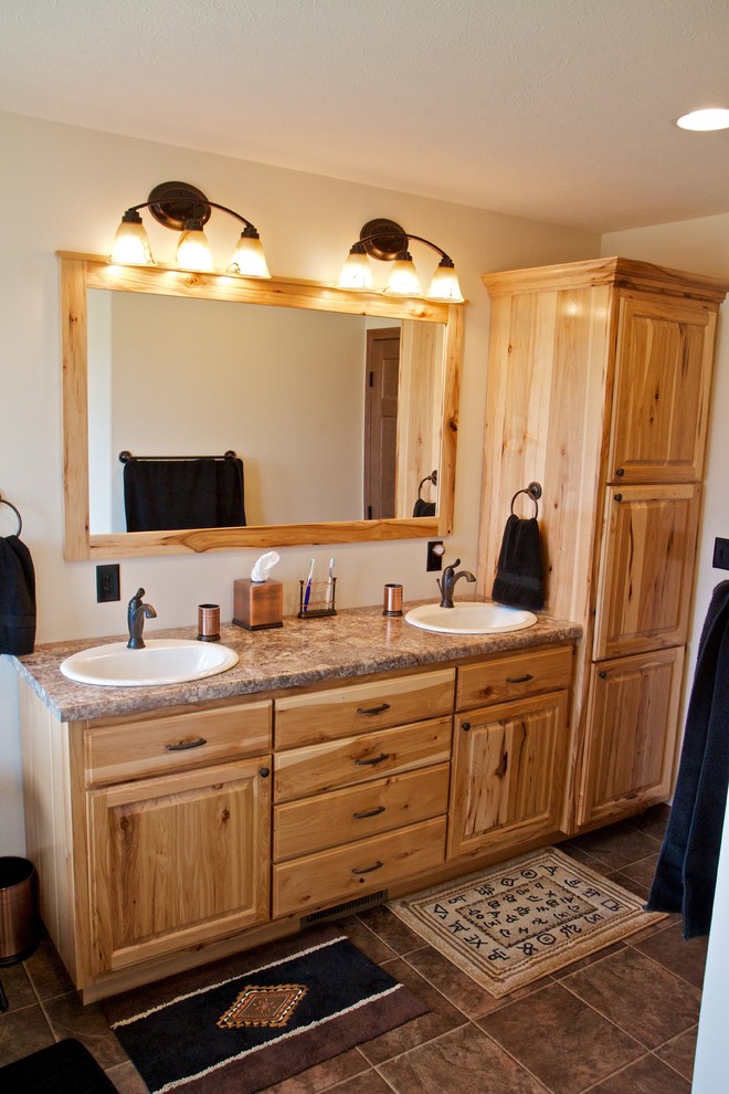 Bathroom - large rustic master bathroom idea with raised-panel cabinets, light wood cabinets and laminate countertops