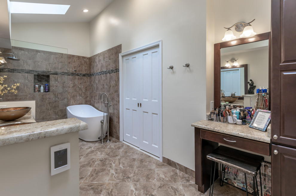 This is an example of a small contemporary master bathroom in DC Metro with brown cabinets, a freestanding tub, an open shower, a one-piece toilet, beige walls, a vessel sink, grey floor, brown benchtops, a double vanity and a built-in vanity.