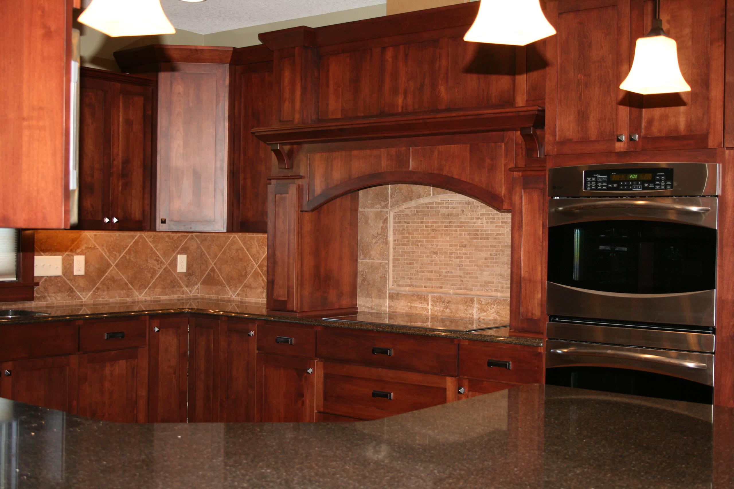 massive cherry craftsman style cabinets with storage galore.  Built in double ovens and cooktop set in durable quarts counter tops for easy cleaning and great look.