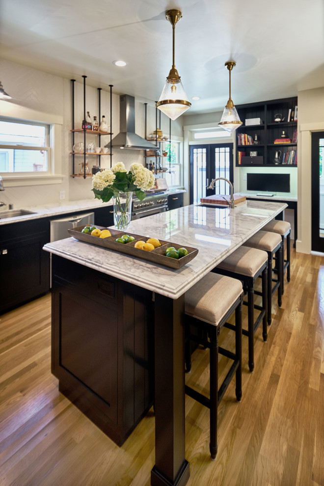 Design ideas for a mid-sized arts and crafts single-wall separate kitchen in San Francisco with an undermount sink, shaker cabinets, black cabinets, marble benchtops, ceramic splashback, stainless steel appliances, light hardwood floors and with island.