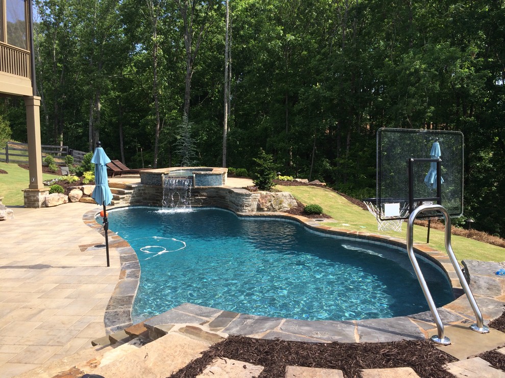 Inspiration for a large rustic backyard custom-shaped natural hot tub remodel in Atlanta