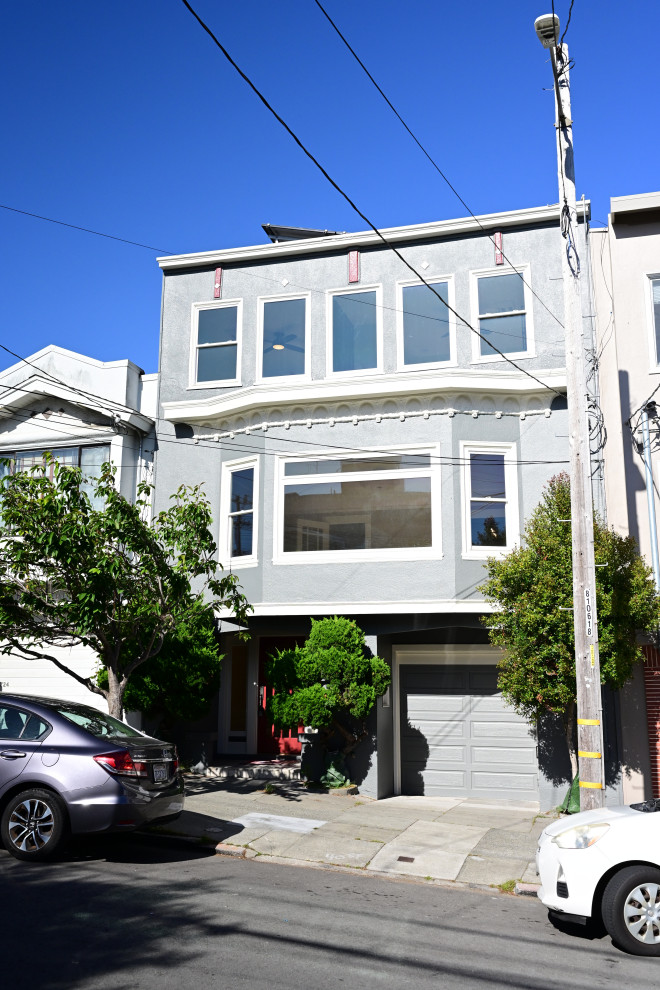 Updated Urban Home Exterior with Bay Window and Attached Garage