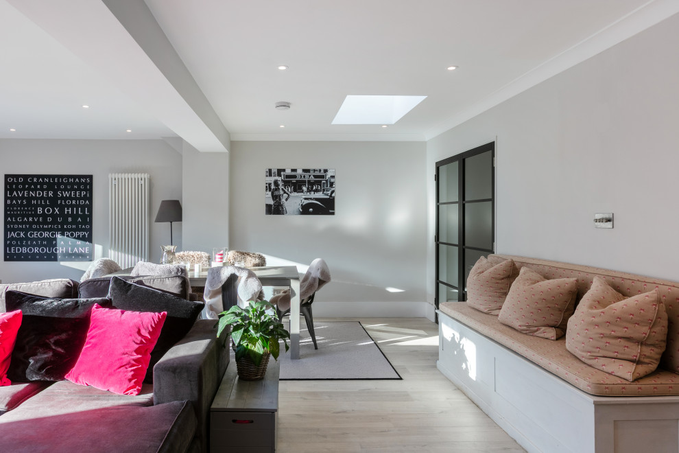 Design ideas for a medium sized contemporary open plan living room in Buckinghamshire with laminate floors and a drop ceiling.