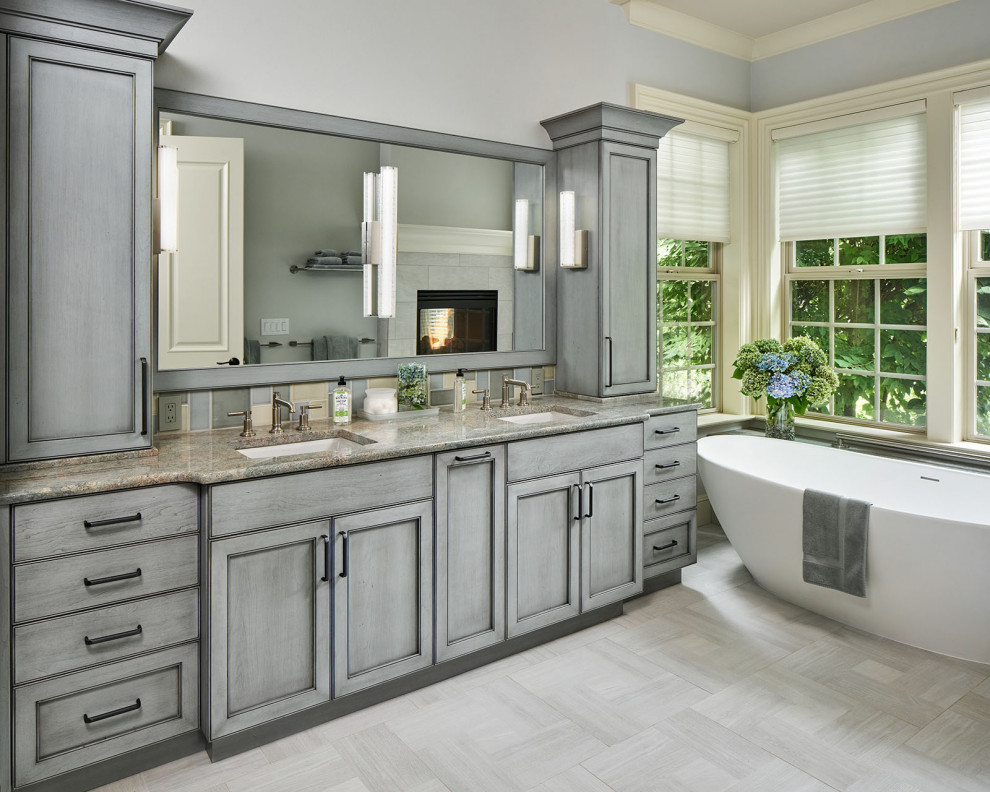 Photo of a large transitional master bathroom in Portland with recessed-panel cabinets, blue cabinets, a freestanding tub, a curbless shower, multi-coloured tile, ceramic tile, porcelain floors, an undermount sink, granite benchtops, grey floor, an open shower, green benchtops, a shower seat, a double vanity and a built-in vanity.
