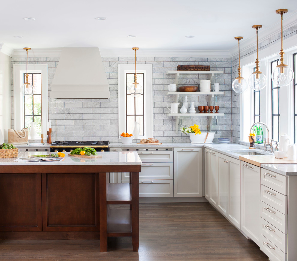 Inspiration for a mid-sized transitional l-shaped open plan kitchen in Atlanta with an undermount sink, recessed-panel cabinets, grey cabinets, marble benchtops, white splashback, black appliances, medium hardwood floors, with island and marble splashback.