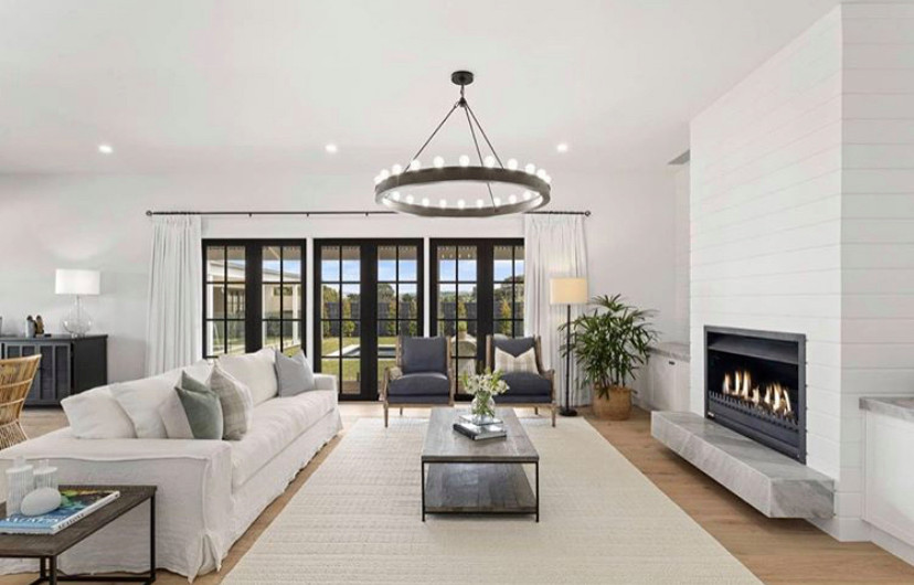 This is an example of a large traditional formal open concept living room in Melbourne with white walls, light hardwood floors, a standard fireplace, a stone fireplace surround, no tv and brown floor.