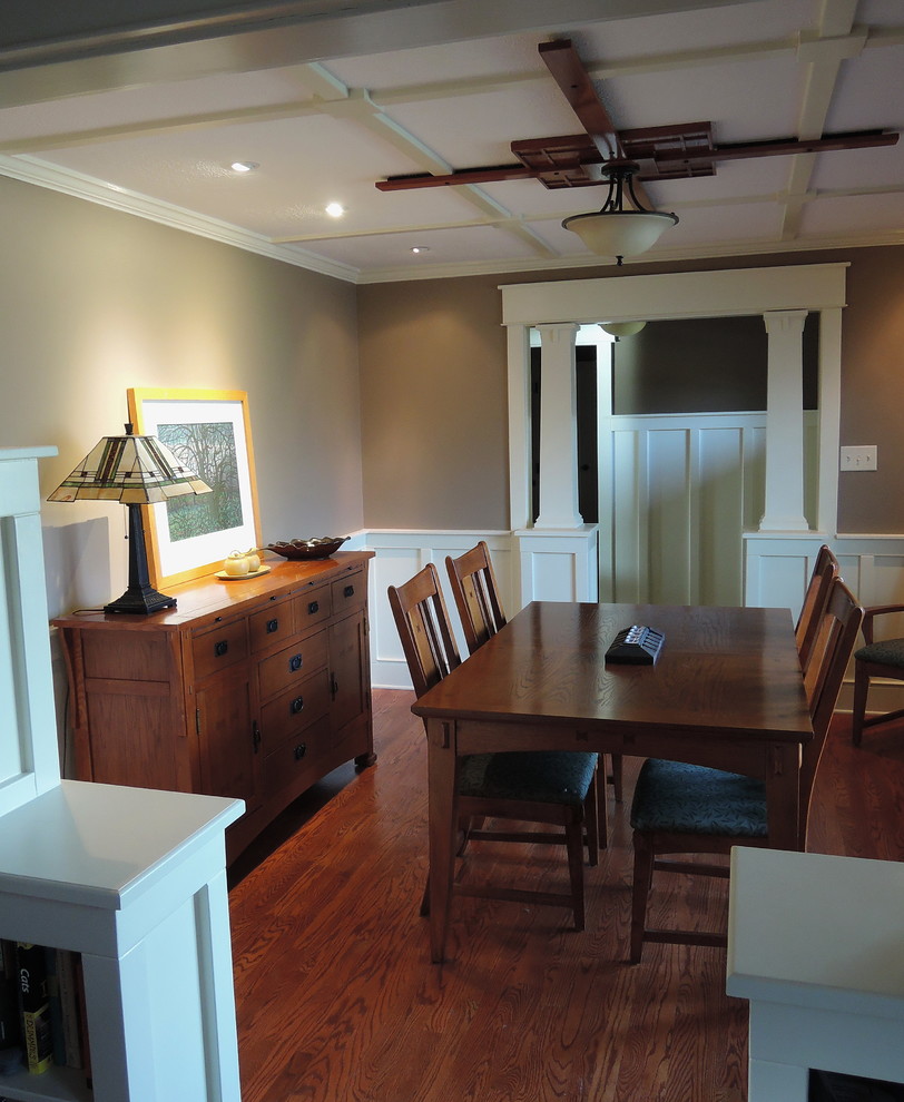 Small arts and crafts separate dining room in Indianapolis with brown walls, medium hardwood floors, no fireplace and brown floor.