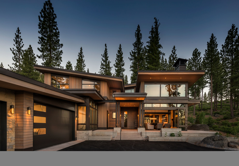 Example of a mountain style brown two-story wood house exterior design in Other with a shed roof