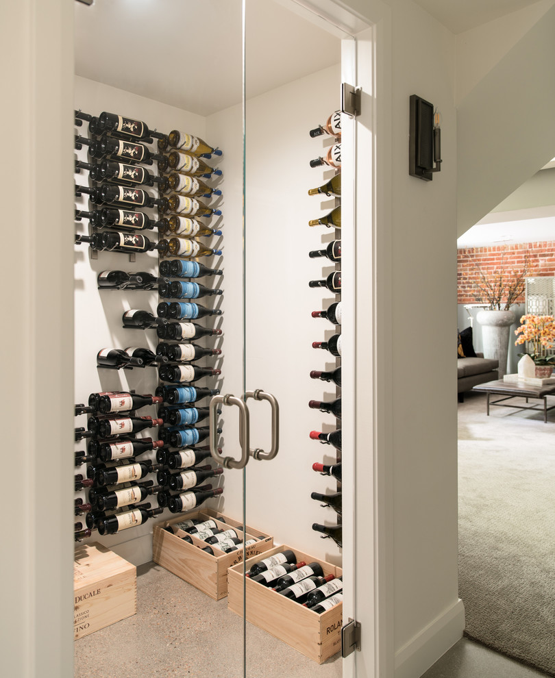 Photo of a small contemporary wine cellar in Orange County with display racks.