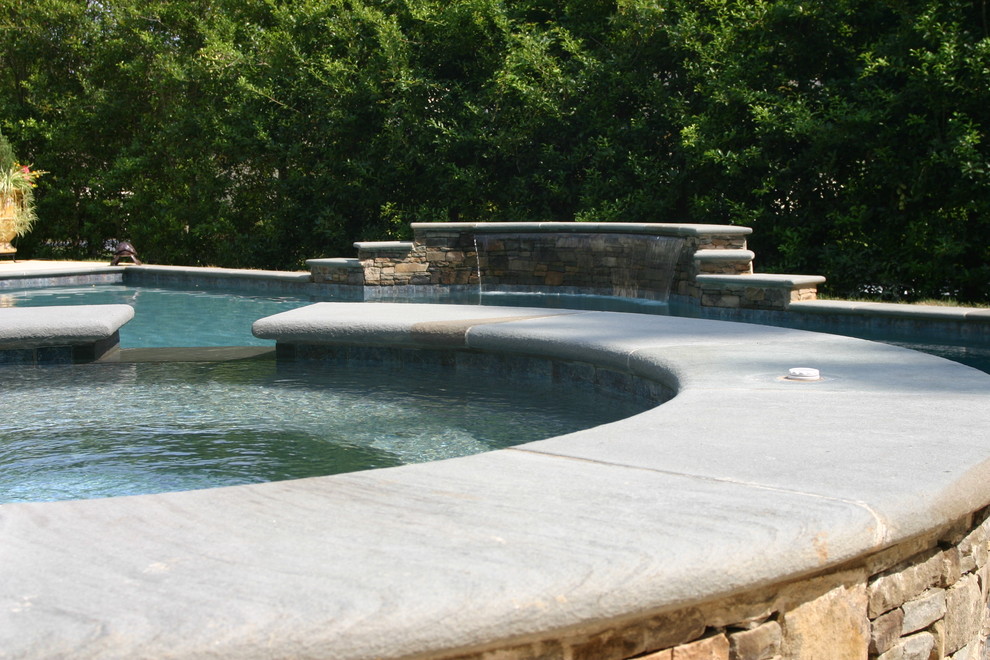 Inspiration for a large transitional backyard stone and custom-shaped lap hot tub remodel in Charlotte