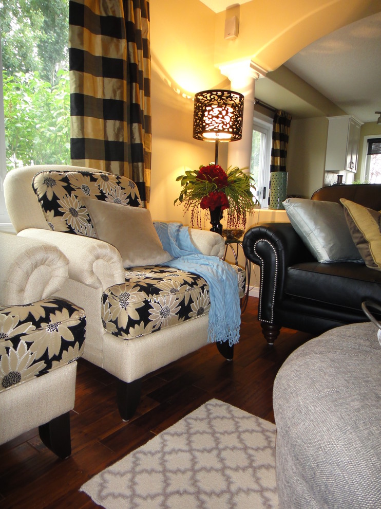 Photo of a mid-sized traditional open concept living room in Edmonton with beige walls and dark hardwood floors.