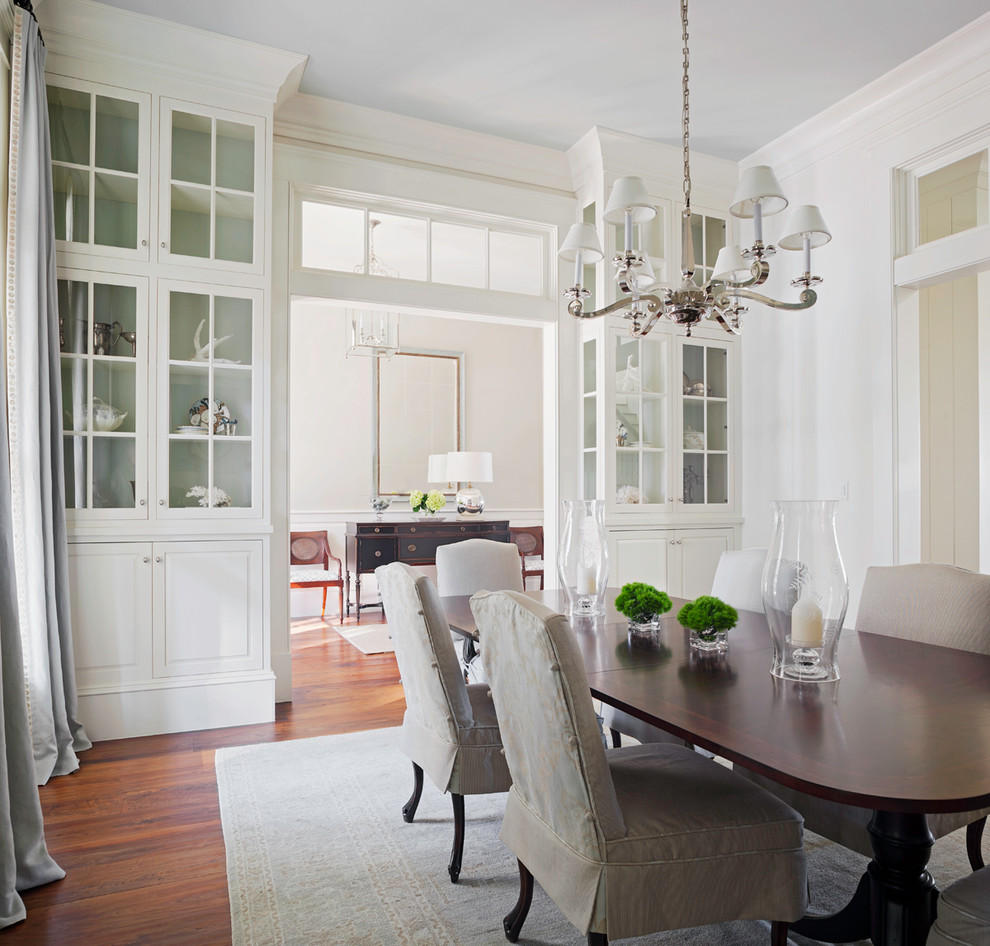 This is an example of a traditional separate dining room in Atlanta with white walls and dark hardwood floors.