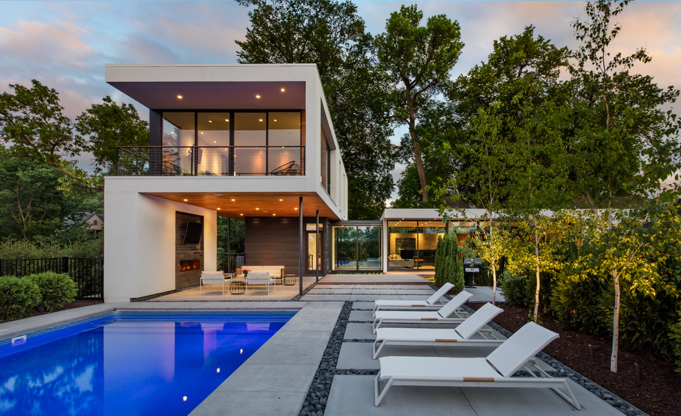 Photo of a contemporary backyard rectangular lap pool in Minneapolis with concrete slab.