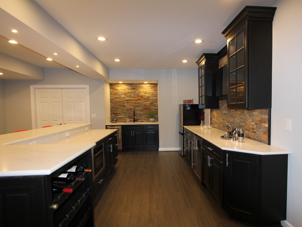 Photo of a large transitional walk-out basement in Baltimore with a home bar, grey walls, vinyl floors and brown floor.