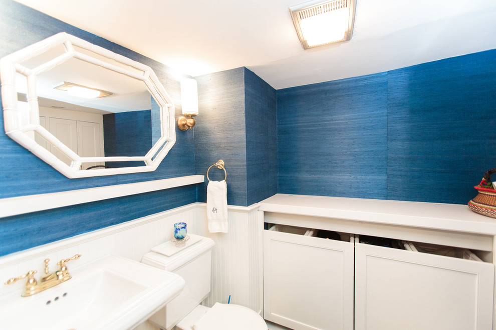 This is an example of a mid-sized traditional utility room in Boston with recessed-panel cabinets and blue walls.