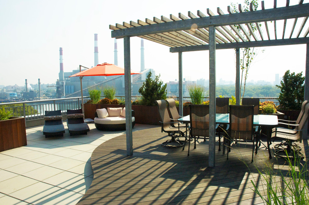Contemporary rooftop and rooftop deck in New York with a pergola.