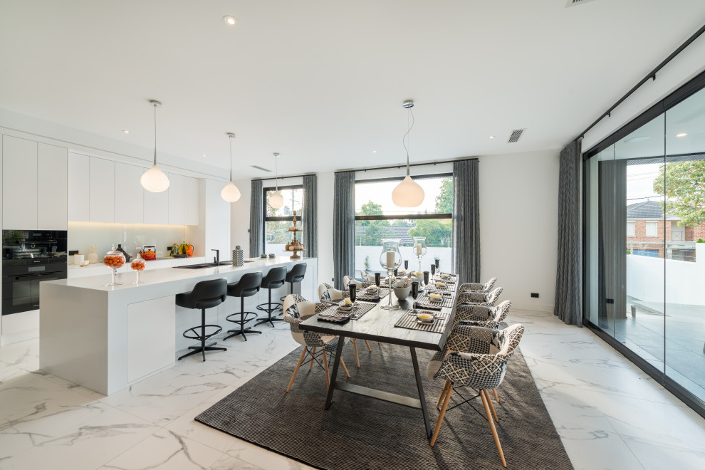 Inspiration for a large contemporary kitchen/dining combo in Melbourne with white walls and grey floor.