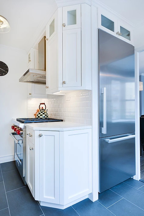 Inspiration for a mid-sized transitional u-shaped gray floor eat-in kitchen remodel with an undermount sink, shaker cabinets, white cabinets, stainless steel appliances and no island