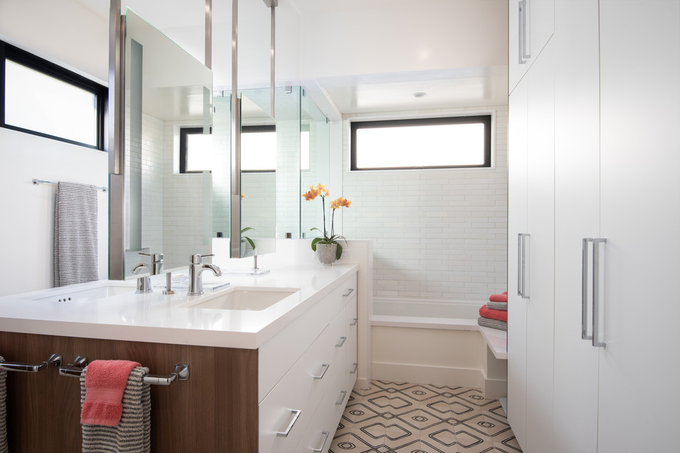 Mid-sized midcentury master bathroom in San Diego with flat-panel cabinets, white cabinets, an undermount tub, white tile, ceramic tile, white walls, cement tiles, an undermount sink, engineered quartz benchtops, a hinged shower door, white benchtops and beige floor.
