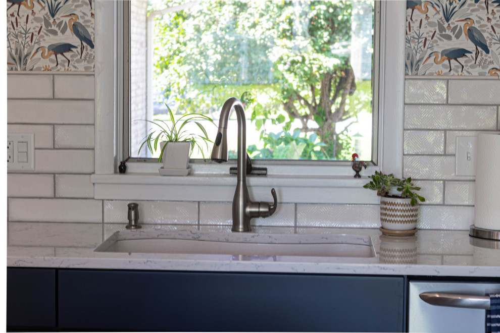 Mid-sized transitional l-shaped porcelain tile and gray floor eat-in kitchen photo with an undermount sink, flat-panel cabinets, white cabinets, quartz countertops, white backsplash, subway tile backsplash, stainless steel appliances, an island and white countertops
