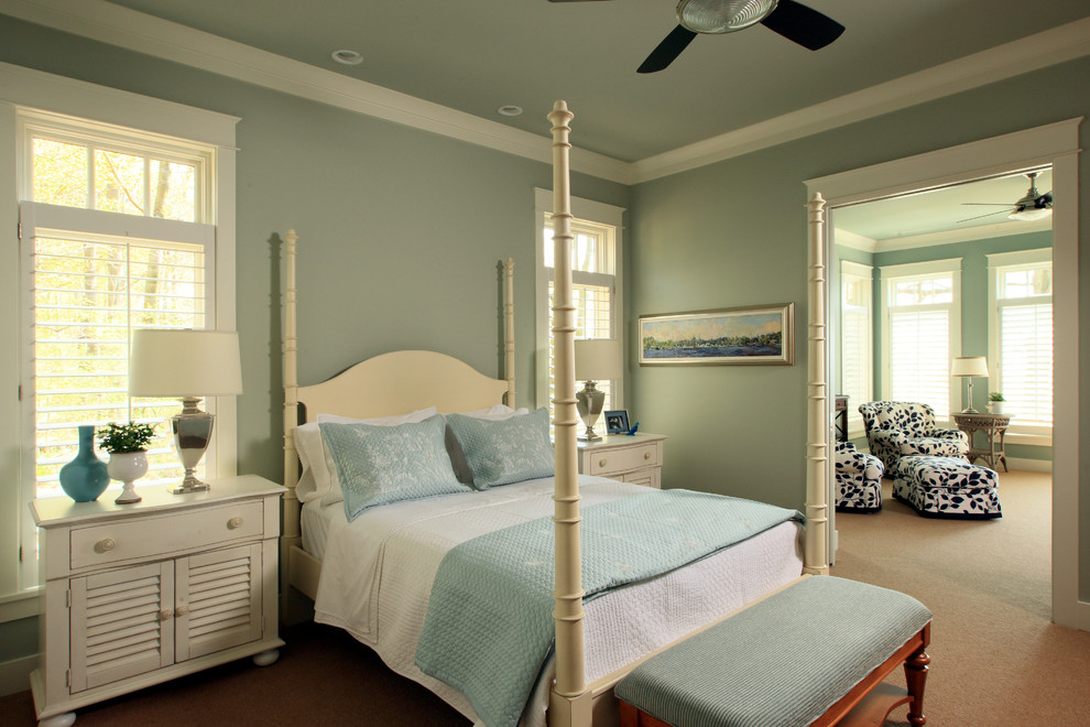 This is an example of a beach style master bedroom in Grand Rapids with blue walls and carpet.