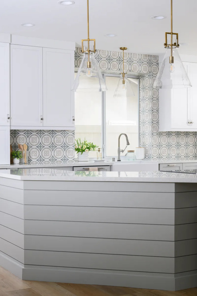 Eat-in kitchen - transitional l-shaped vinyl floor and brown floor eat-in kitchen idea in Orange County with a farmhouse sink, shaker cabinets, gray cabinets, quartz countertops, multicolored backsplash, porcelain backsplash, stainless steel appliances, an island and white countertops